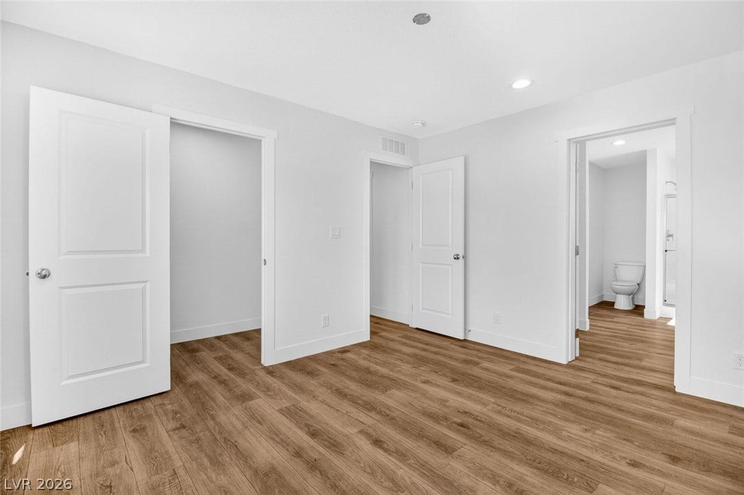 2258 Toiyabe Street, Las Vegas, NV 89156 Rich wood-look flooring contrasts beautifully with crisp white walls and multiple entryways.
