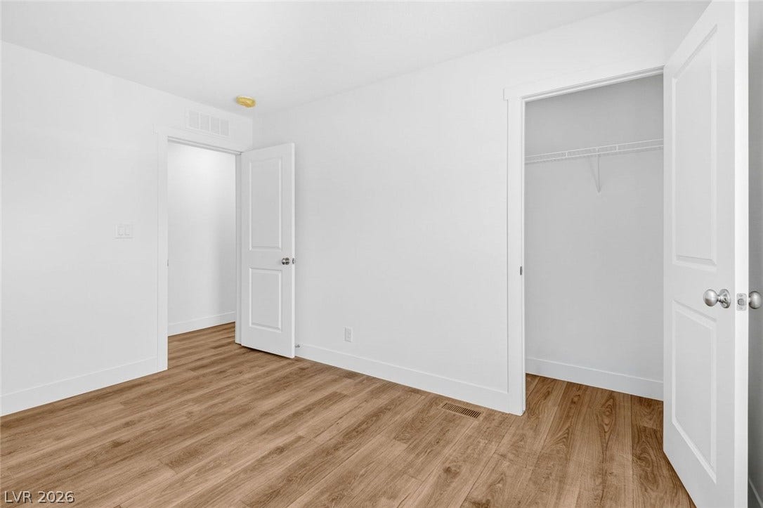 2258 Toiyabe Street, Las Vegas, NV 89156 Rich wood-plank flooring warms this light-filled room complete with a built-in closet.