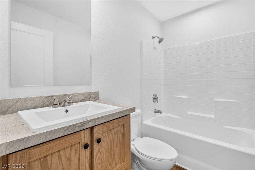 2258 Toiyabe Street, Las Vegas, NV 89156 Clean tiling and a wood vanity define this functional bathroom space.