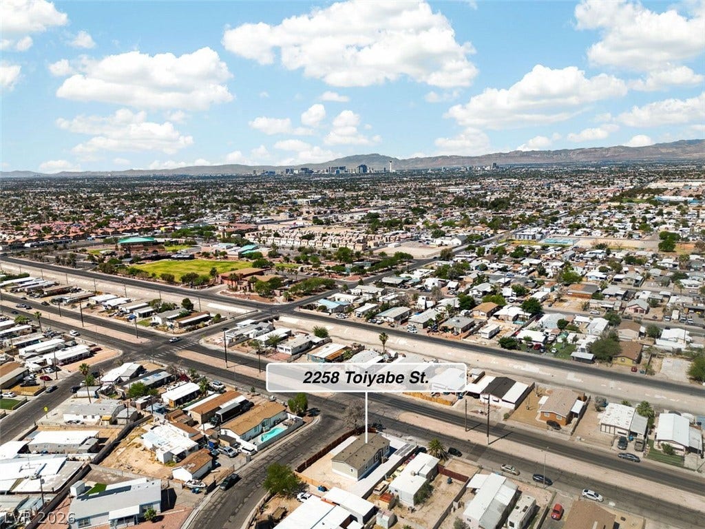 2258 Toiyabe Street, Las Vegas, NV 89156 An aerial perspective reveals the neighborhood landscape with mountain and city skyline views in the distance.