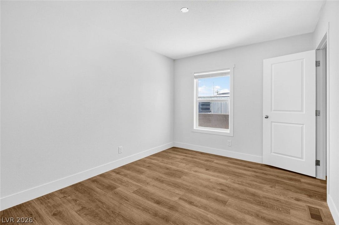 2258 Toiyabe Street, Las Vegas, NV 89156 Rich wood-look flooring sets a warm foundation in this inviting bedroom space.