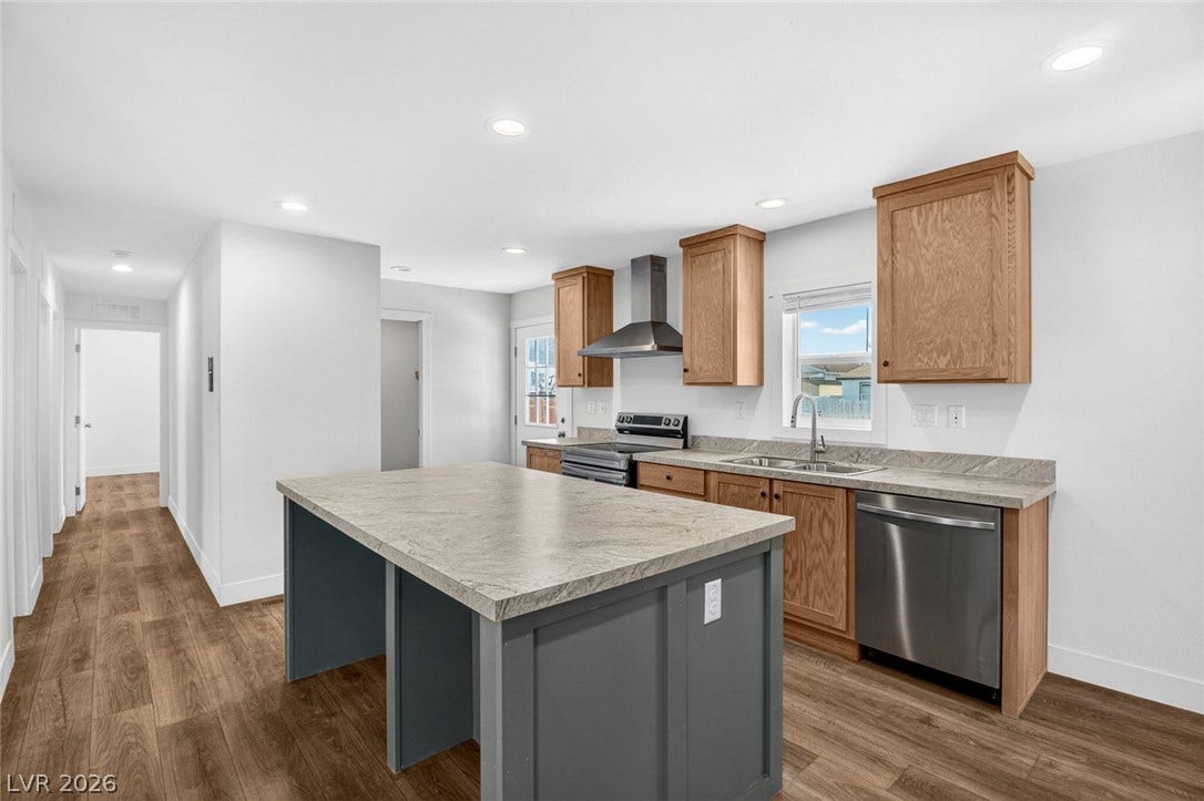2258 Toiyabe Street, Las Vegas, NV 89156 Rich wood cabinetry contrasts beautifully with a modern center island and neutral countertops.
