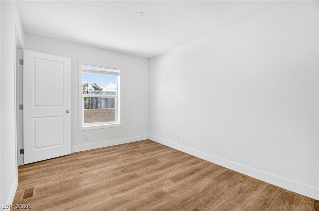 2258 Toiyabe Street, Las Vegas, NV 89156 Rich wood-look flooring sets a warm foundation in this sunlit room.