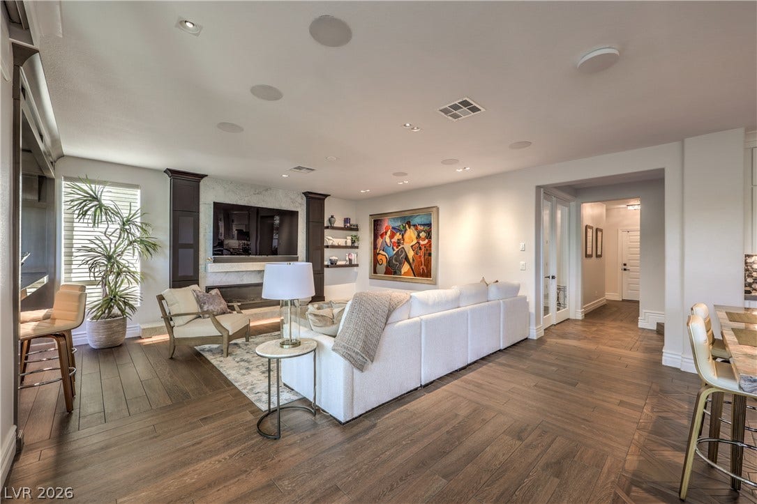 Beautifully remodeled family room featuring a 72-inch linear gas fireplace, built-in television, surround sound and custom woodwork