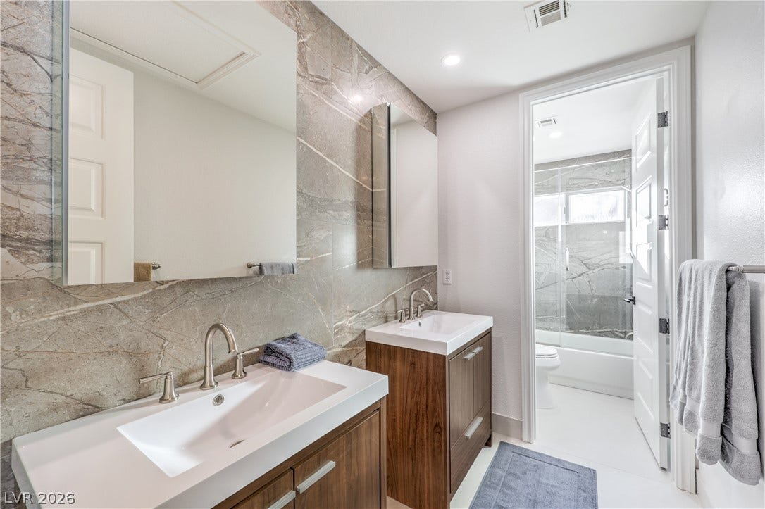 Remodeled hall bath with double vanities