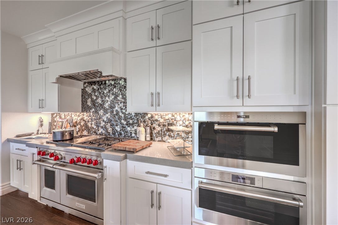 A true gourmet kitchen featuring a dual-fuel Wolf range, steam oven, microwave, pot filler,