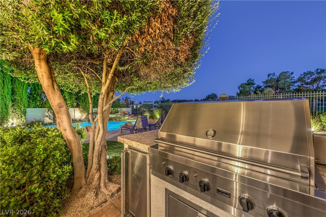 Built-in Wolf stainless BBQ and outdoor refrigerator with golf course view