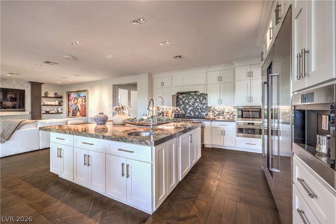 Custom island, with large sink and second vegetable sink, 72 in. sub-zero refrigerator, wine refrigerator, wolf built-in coffee maker, wolf steam oven