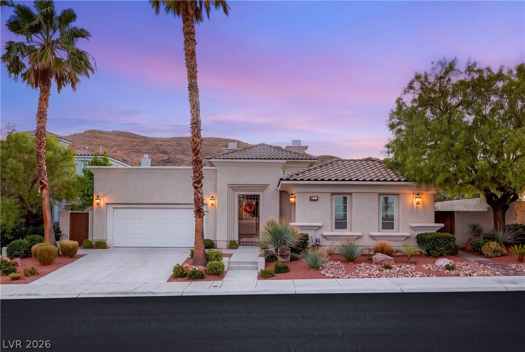 2575 Turtle Head Peak Drive, Las Vegas, NV 89135 Desert landscaping and a tiled roof complement this elegant residence framed by mountain views.