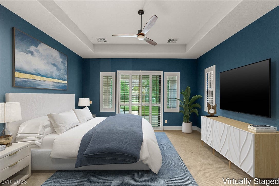 2575 Turtle Head Peak Drive, Las Vegas, NV 89135 An elegant tray ceiling and custom window shutters elevate this spacious bedroom design.