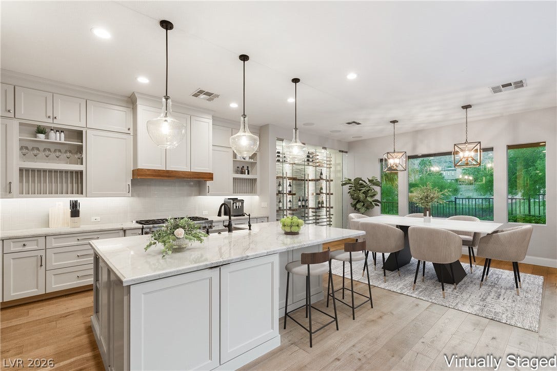 2575 Turtle Head Peak Drive, Las Vegas, NV 89135 An open kitchen and dining area showcase warm wood flooring beneath recessed lighting.