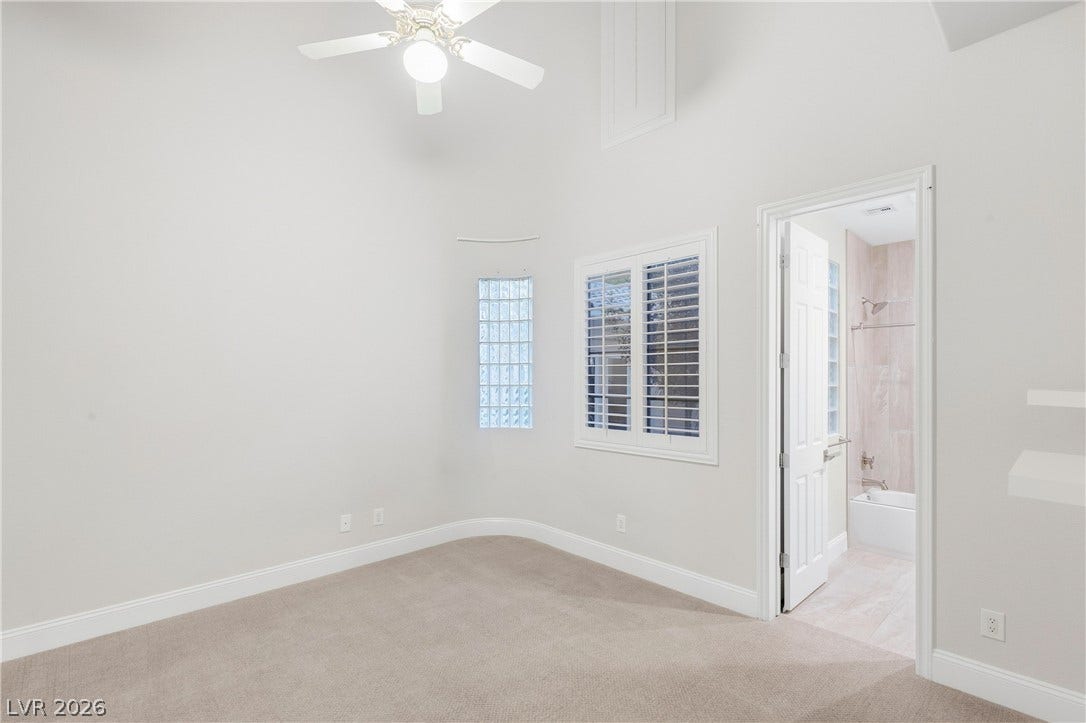 2575 Turtle Head Peak Drive, Las Vegas, NV 89135 High ceilings and soft carpeting create a tranquil retreat with an attached bath.