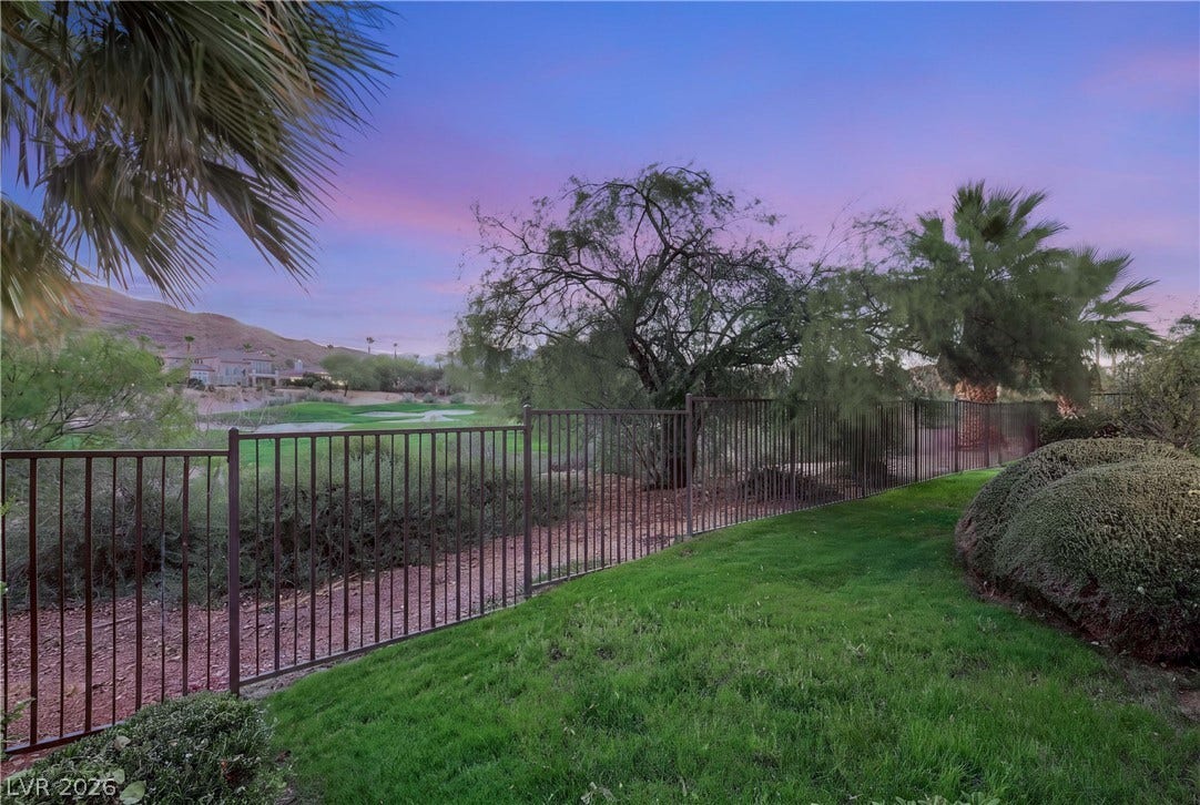 2575 Turtle Head Peak Drive, Las Vegas, NV 89135 Lush green lawns and secure fencing frame beautiful golf course and desert mountain views.