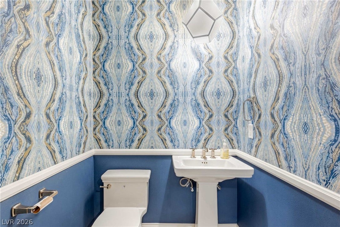 2575 Turtle Head Peak Drive, Las Vegas, NV 89135 Ornate wallcoverings and classic wainscoting define this elegantly finished powder room.