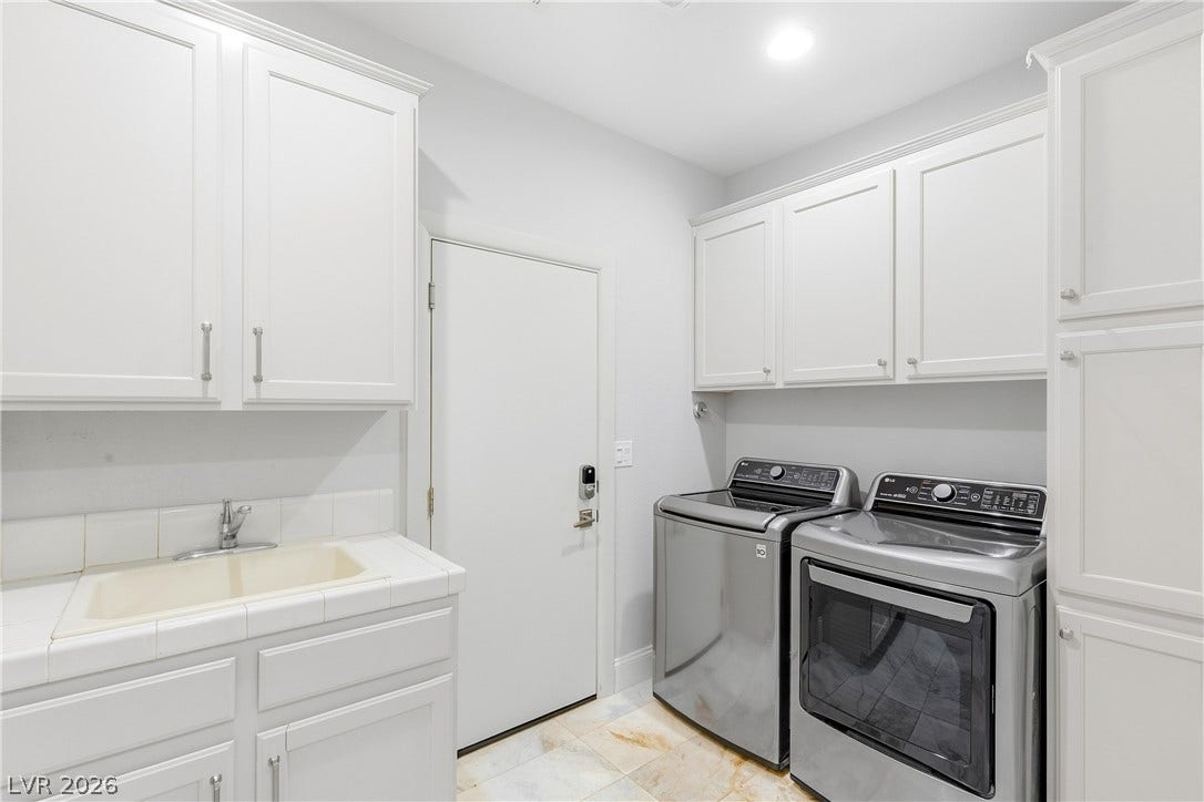 2575 Turtle Head Peak Drive, Las Vegas, NV 89135 Ample built-in cabinetry and a utility sink maximize organization in this functional laundry room.