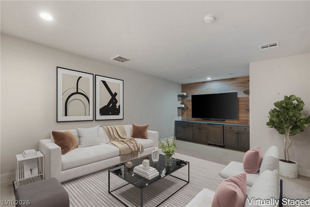 2575 Turtle Head Peak Drive, Las Vegas, NV 89135 An inviting media room features a custom wood-paneled entertainment wall and plush carpeting.