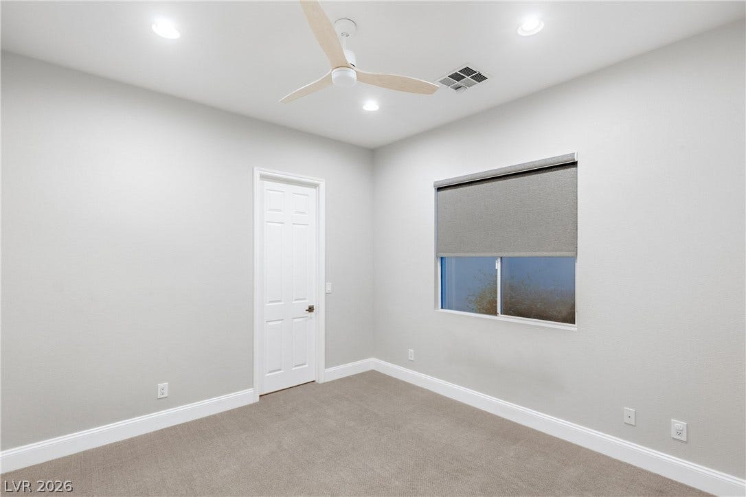 2575 Turtle Head Peak Drive, Las Vegas, NV 89135 Recessed lighting illuminates this clean bedroom space with soft neutral carpeting.