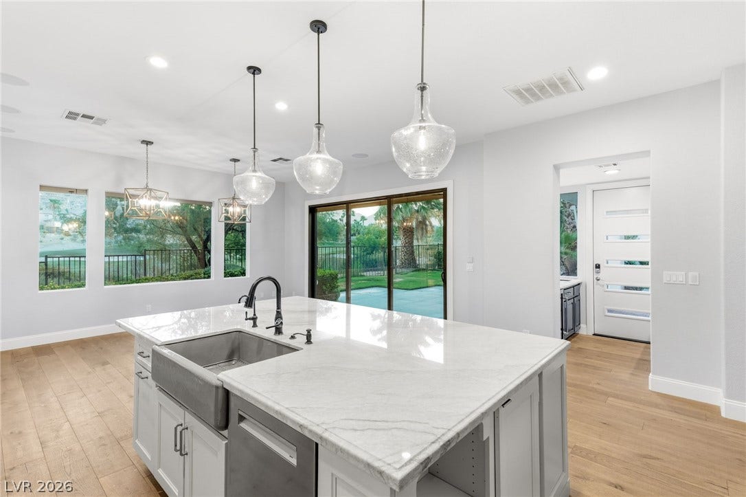 2575 Turtle Head Peak Drive, Las Vegas, NV 89135 Gleaming stone countertops and warm wood floors define this open culinary space.