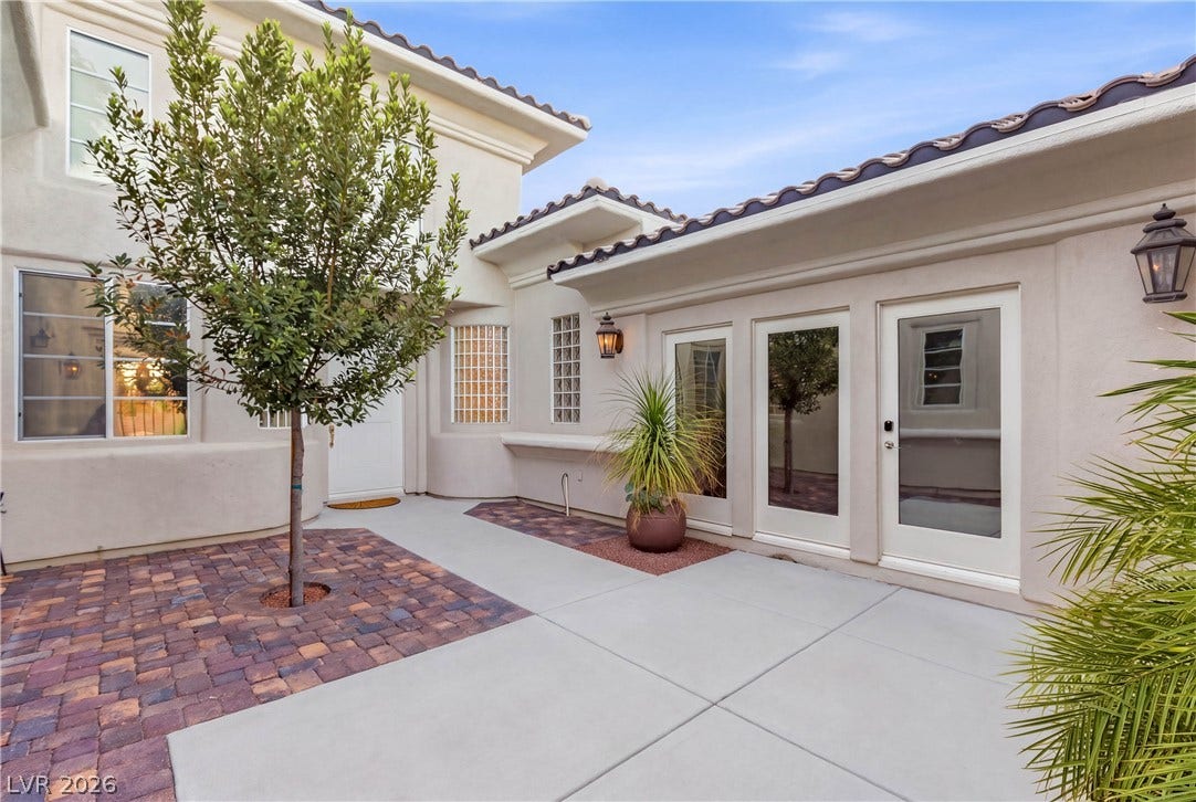 2575 Turtle Head Peak Drive, Las Vegas, NV 89135 A private paved courtyard provides a serene entry and transition space with Spanish tile roofing.