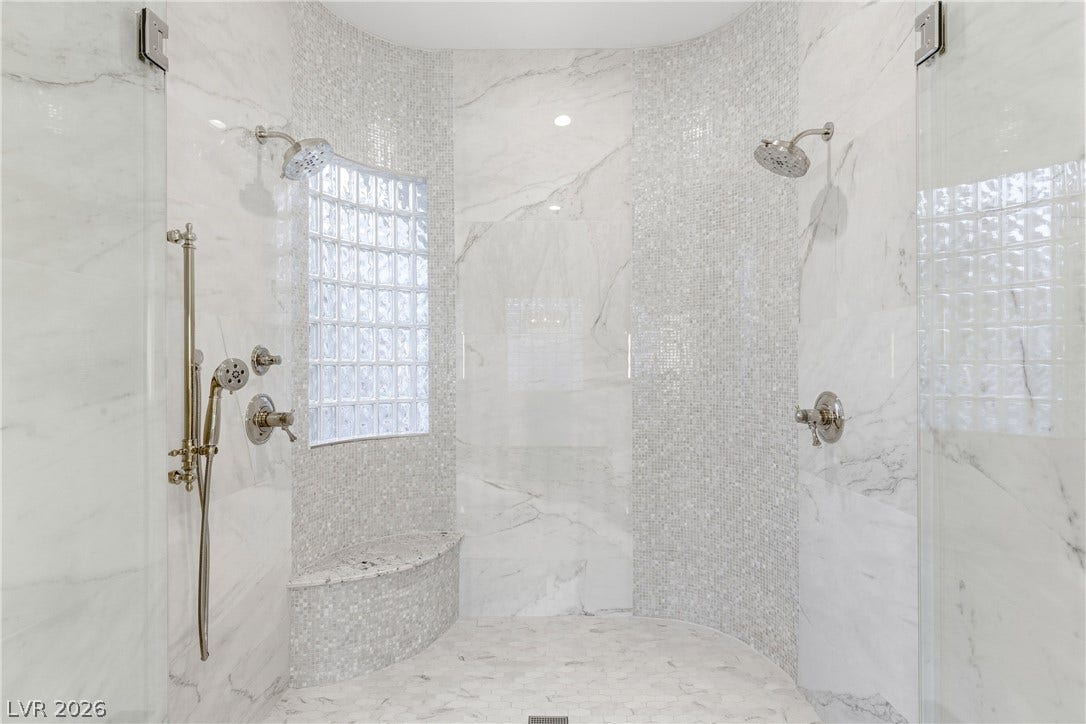 2575 Turtle Head Peak Drive, Las Vegas, NV 89135 Custom tile work and premium marble finishes define this walk-in shower experience.