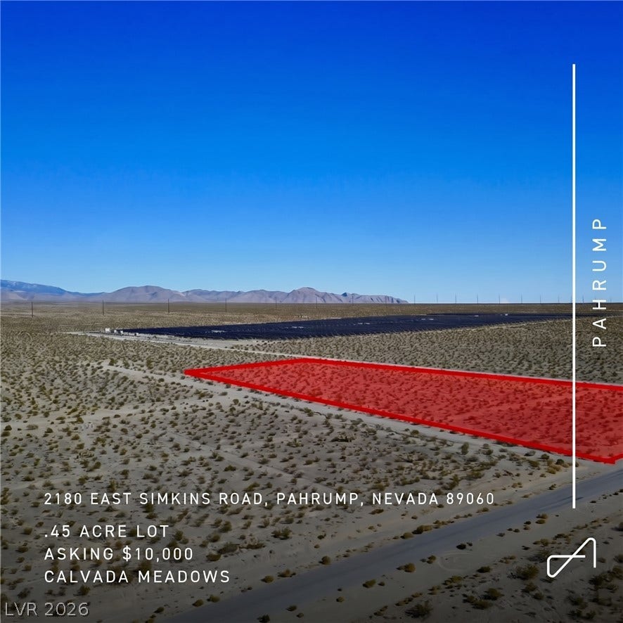 2180 E Simkins Road, Pahrump, NV 89060 A spacious desert parcel presents panoramic mountain views under clear blue skies.