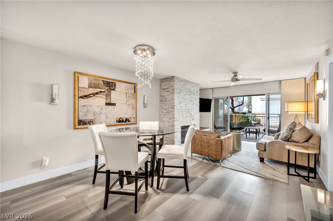 Beautiful LVP flooring and a stone-faced fireplace accent this open-concept layout.