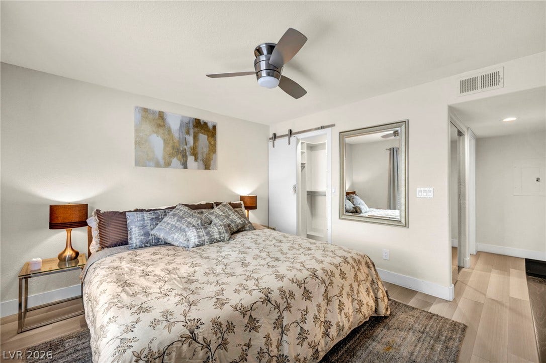 A serene bedroom layout featuring a sliding barn door closet and en suite.
