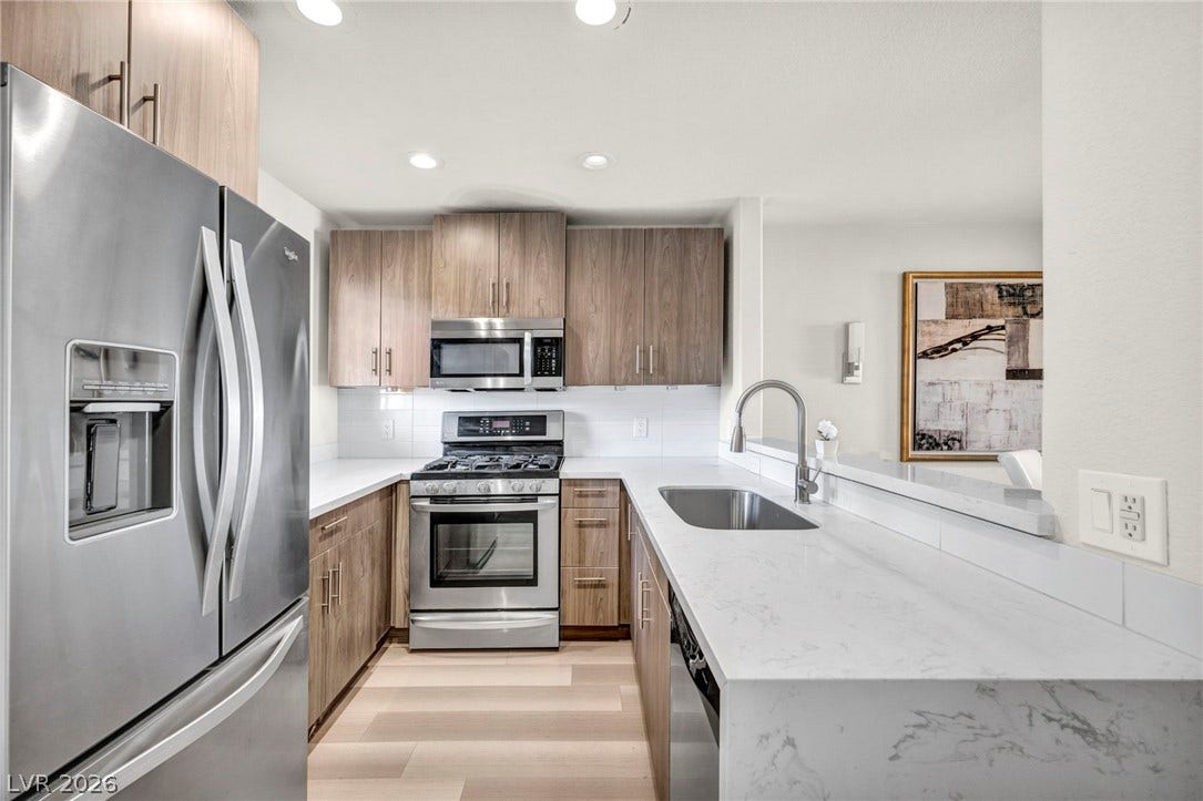 Streamlined cabinetry and sleek countertops frame this modern culinary space.