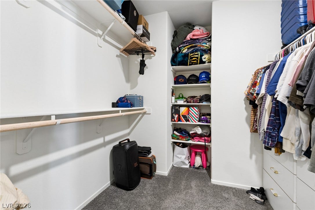 7910 Aurora Sky Street, North Las Vegas, NV 89084 Ample storage options define this functional walk-in closet featuring built-in shelving.