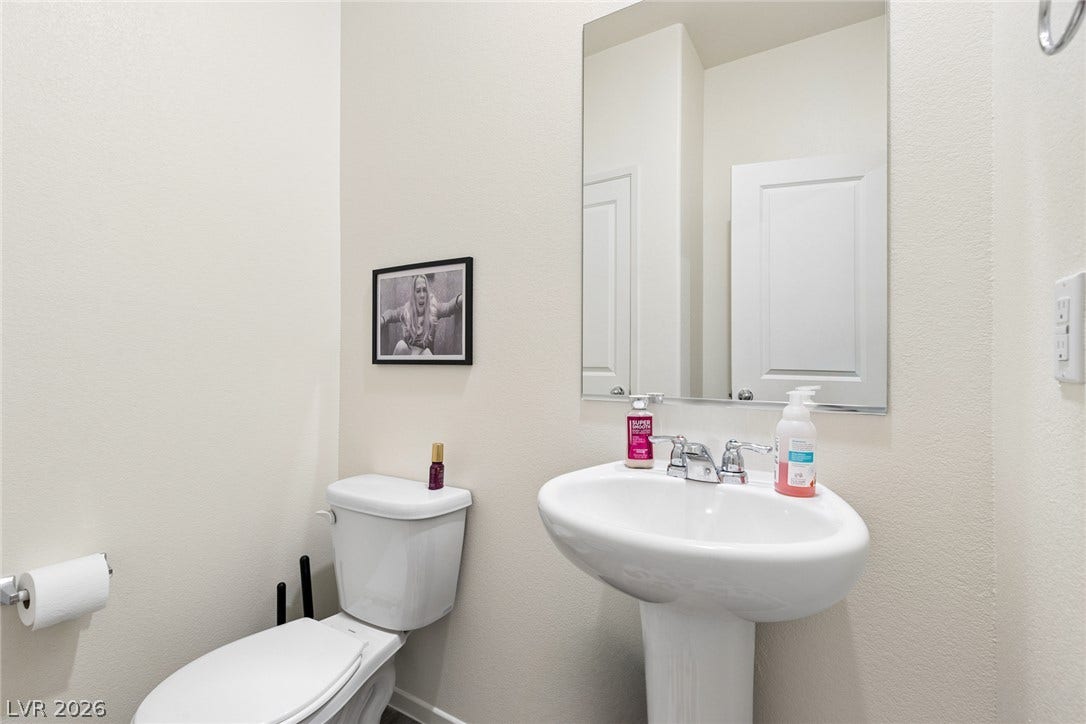 7910 Aurora Sky Street, North Las Vegas, NV 89084 Clean lines and classic fixtures define this simple, elegant powder room.