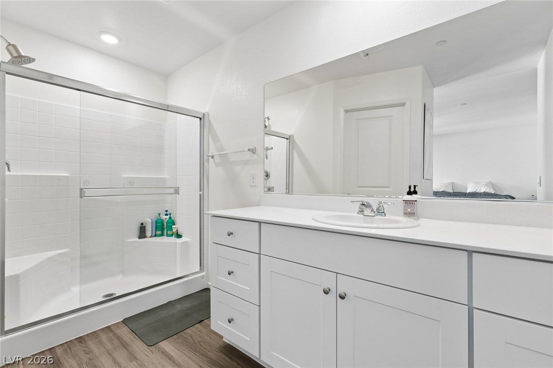 7910 Aurora Sky Street, North Las Vegas, NV 89084 Clean lines and a spacious glass-enclosed shower define this modern bathroom space.