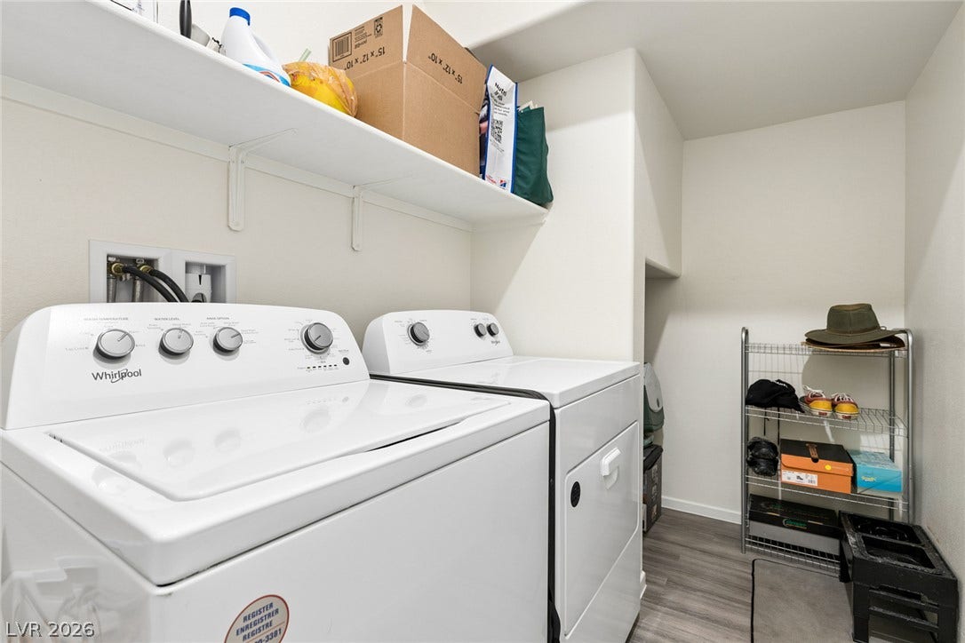7910 Aurora Sky Street, North Las Vegas, NV 89084 Functional utility space features durable hard surface flooring and high-mounted shelving above the laundry appliances.