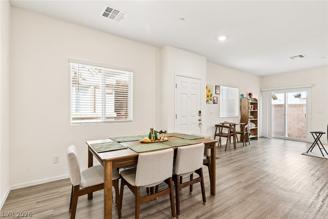 7910 Aurora Sky Street, North Las Vegas, NV 89084 An open dining area flows toward the backyard through large sliding glass doors.