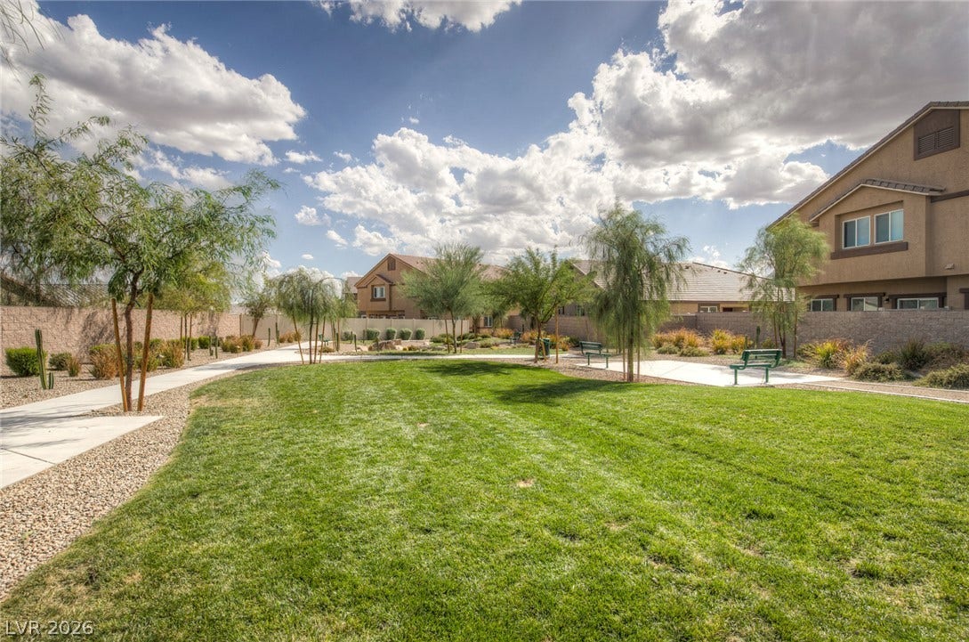 7910 Aurora Sky Street, North Las Vegas, NV 89084 Paved walking paths wind through a manicured green belt within the community.