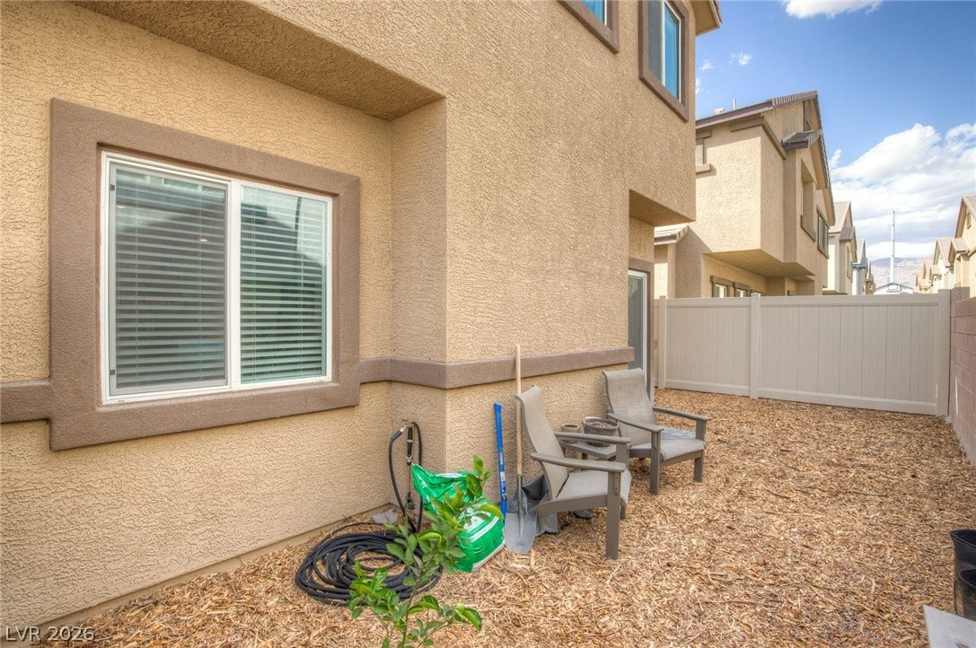 7910 Aurora Sky Street, North Las Vegas, NV 89084 A private fenced backyard provides low-maintenance outdoor space alongside the stucco exterior.