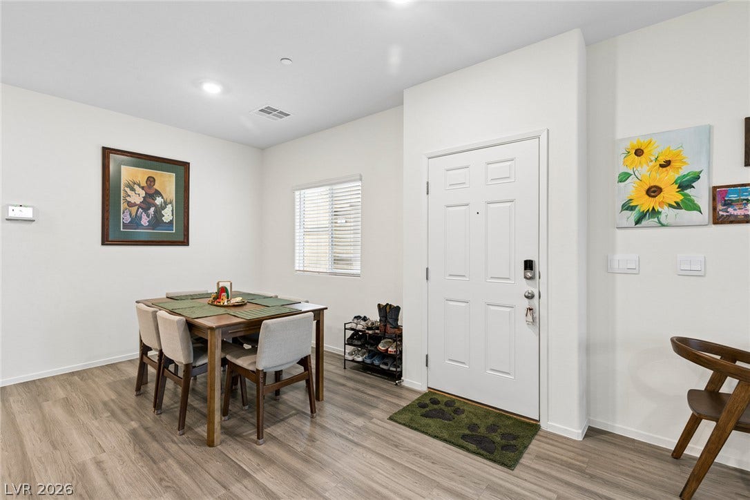 7910 Aurora Sky Street, North Las Vegas, NV 89084 Smooth wood-style flooring and recessed lighting define this inviting entryway dining space.