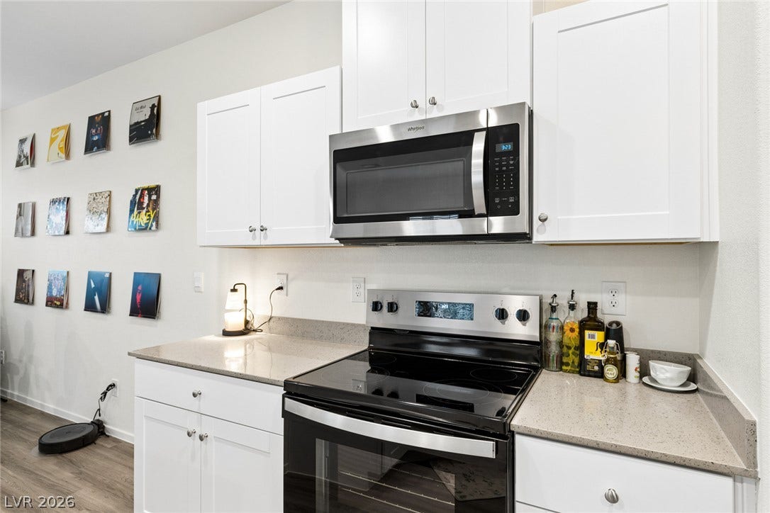 7910 Aurora Sky Street, North Las Vegas, NV 89084 Sleek stainless steel appliances integrate seamlessly with clean white cabinetry and stone countertops.
