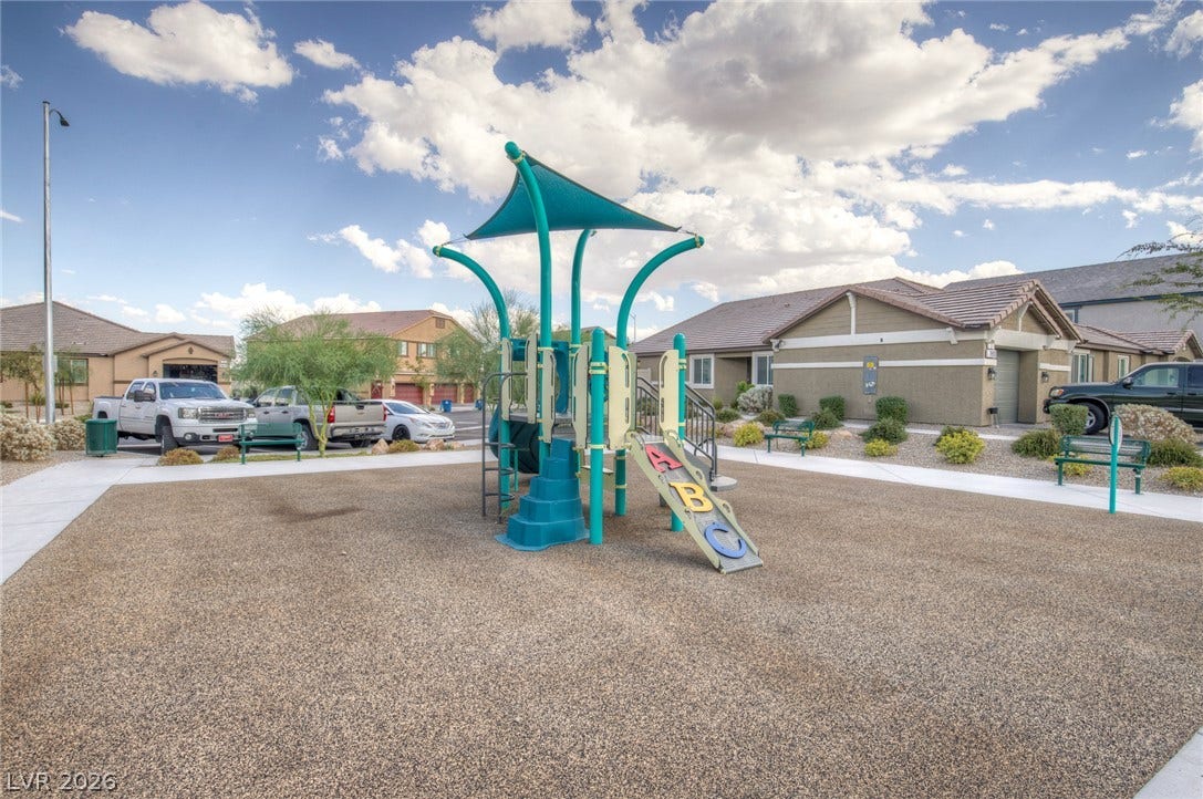 7910 Aurora Sky Street, North Las Vegas, NV 89084 An outdoor neighborhood recreation space provides structured play equipment set against suburban homes.