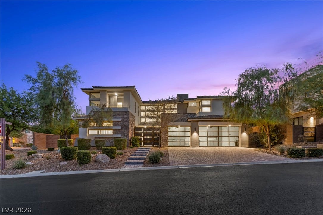 11453 Rhodolite Court, Las Vegas, NV 89135 Modern architectural lines and stone accents define this contemporary exterior under a twilight sky.