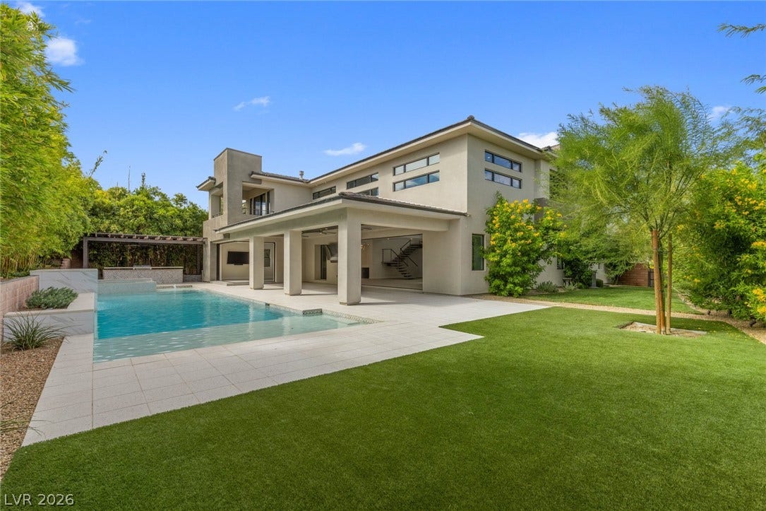 11453 Rhodolite Court, Las Vegas, NV 89135 A sparkling geometric pool anchors the manicured lawn of this modern multi-level residence.
