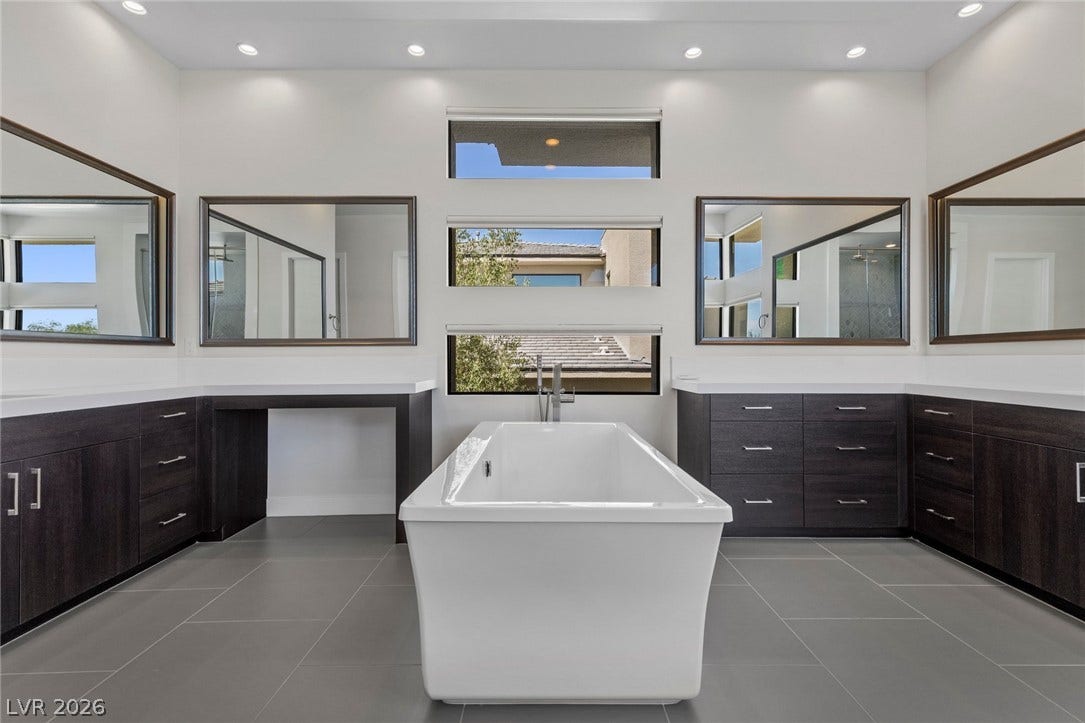 11453 Rhodolite Court, Las Vegas, NV 89135 Clean lines and a freestanding tub define this contemporary primary bathroom retreat.
