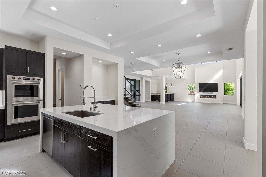 11453 Rhodolite Court, Las Vegas, NV 89135 Gleaming tile floors and clean architectural lines define this expansive, modern open-concept space.