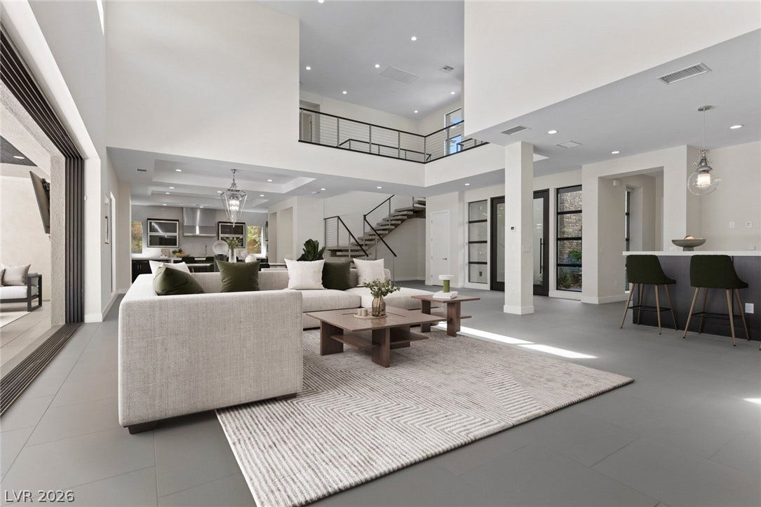 11453 Rhodolite Court, Las Vegas, NV 89135 Double-height ceilings and a wall of glass doors define this modern open-concept space.