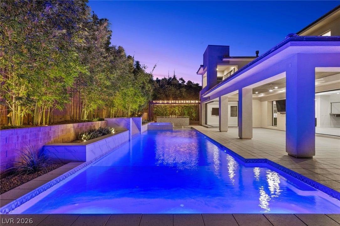 11453 Rhodolite Court, Las Vegas, NV 89135 An inviting swimming pool and covered patio stand ready for twilight relaxation.
