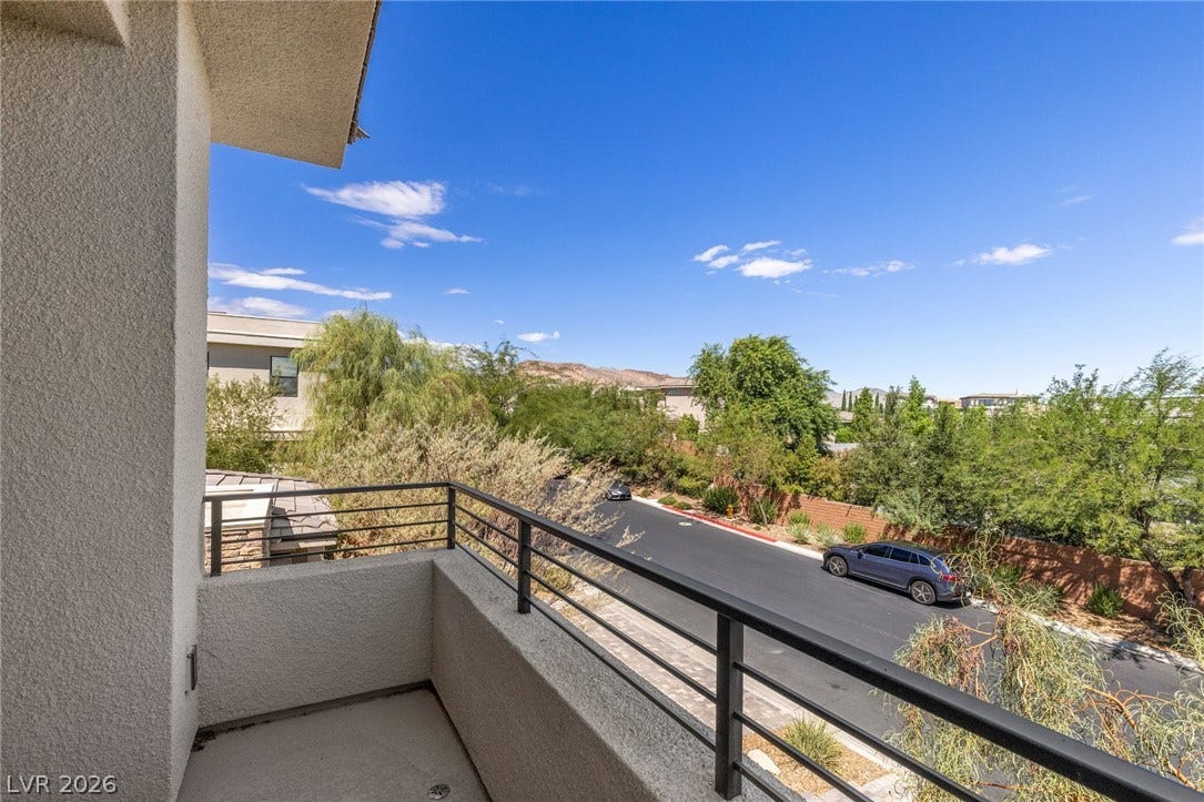 11453 Rhodolite Court, Las Vegas, NV 89135 An elevated perspective captures neighborhood vistas from a private balcony with stucco finishes.
