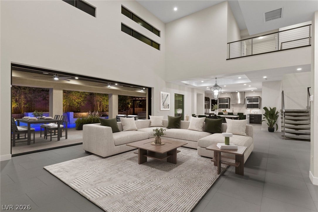 11453 Rhodolite Court, Las Vegas, NV 89135 Voluminous ceilings and glass sliding doors define this modern open-concept main living space.