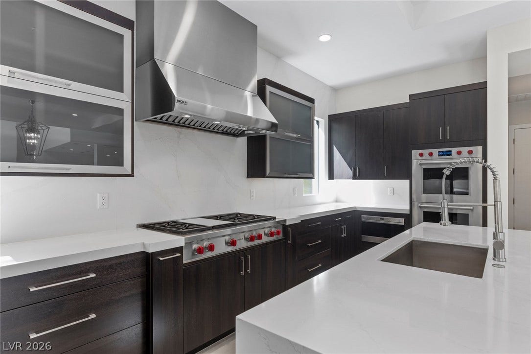 11453 Rhodolite Court, Las Vegas, NV 89135 Premium quartz countertops and professional stainless steel appliances ground this sleek kitchen space.