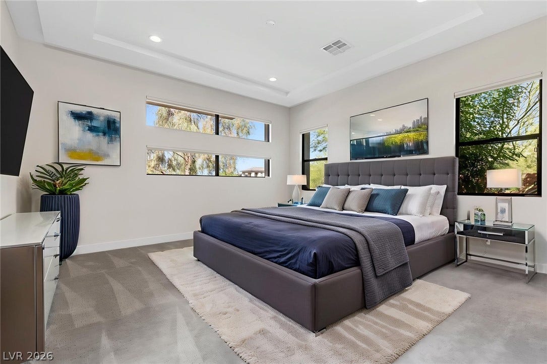 11453 Rhodolite Court, Las Vegas, NV 89135 High recessed-lit ceilings and clean-lined concrete flooring anchor this modern bedroom retreat.