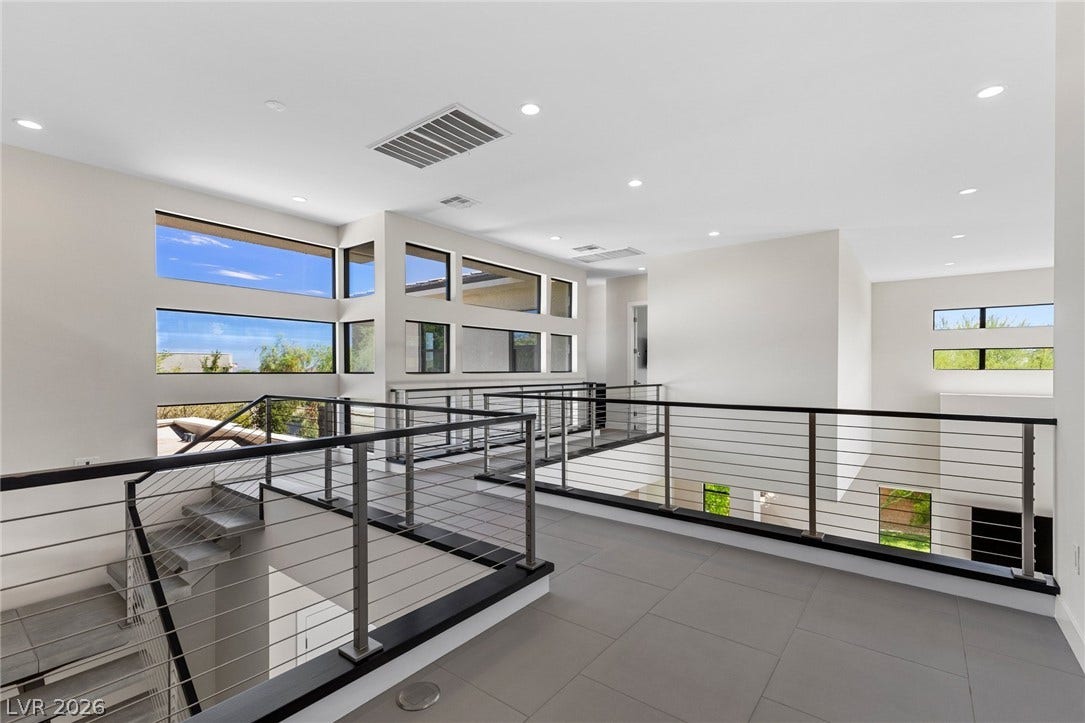 11453 Rhodolite Court, Las Vegas, NV 89135 A modern cat walk features sleek metal railings alongside large architectural windows.