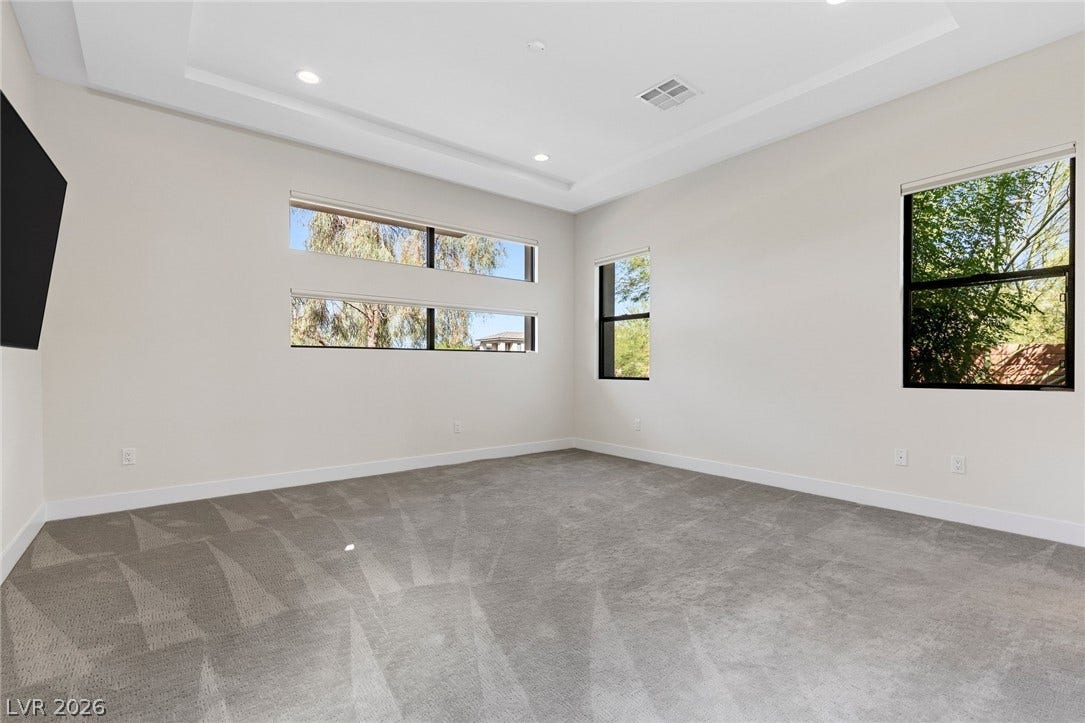 11453 Rhodolite Court, Las Vegas, NV 89135 Recessed lighting and custom windows illuminate this comfortable carpeted space.